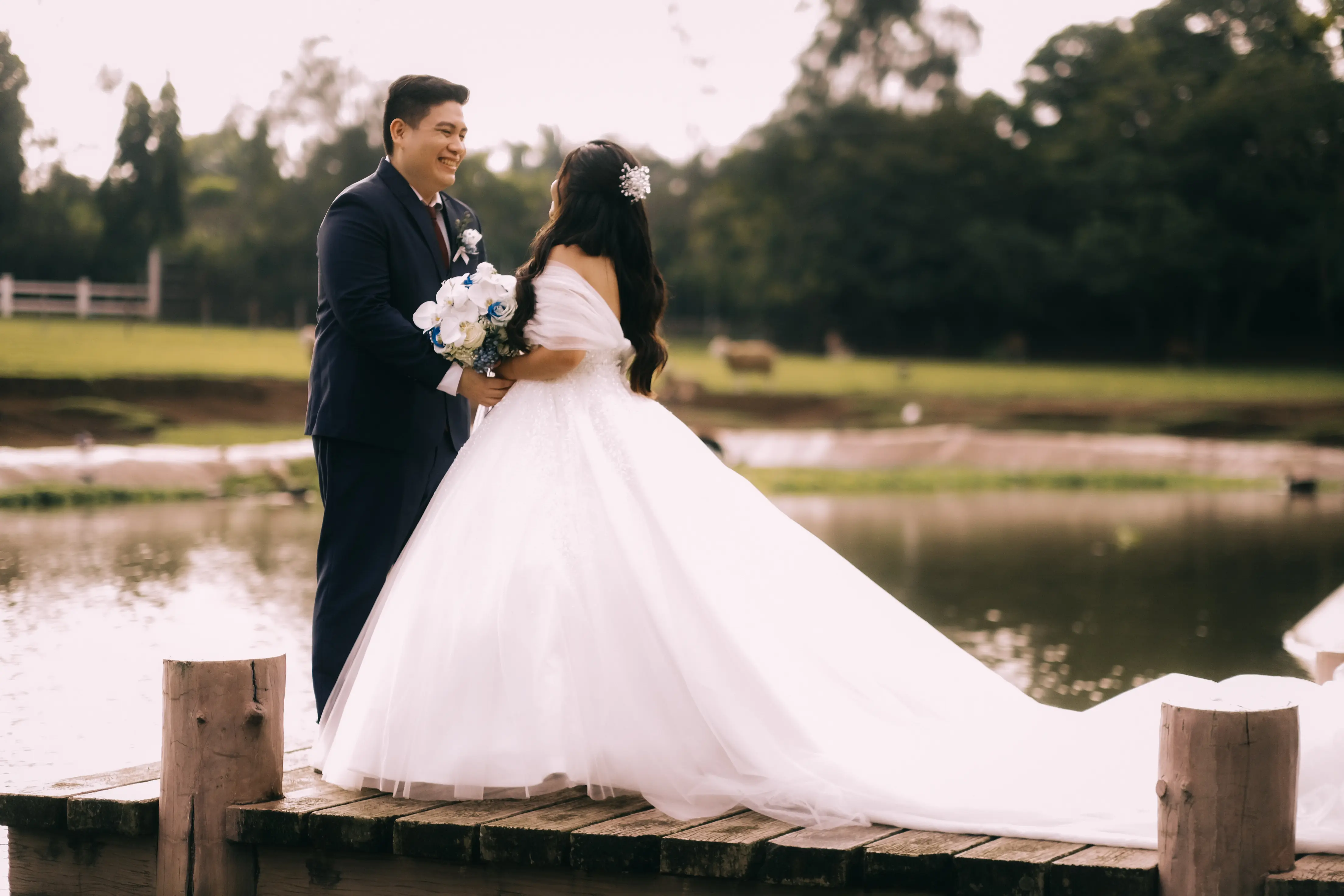 fran and luisa photo on a wooden bridge in front of a lake