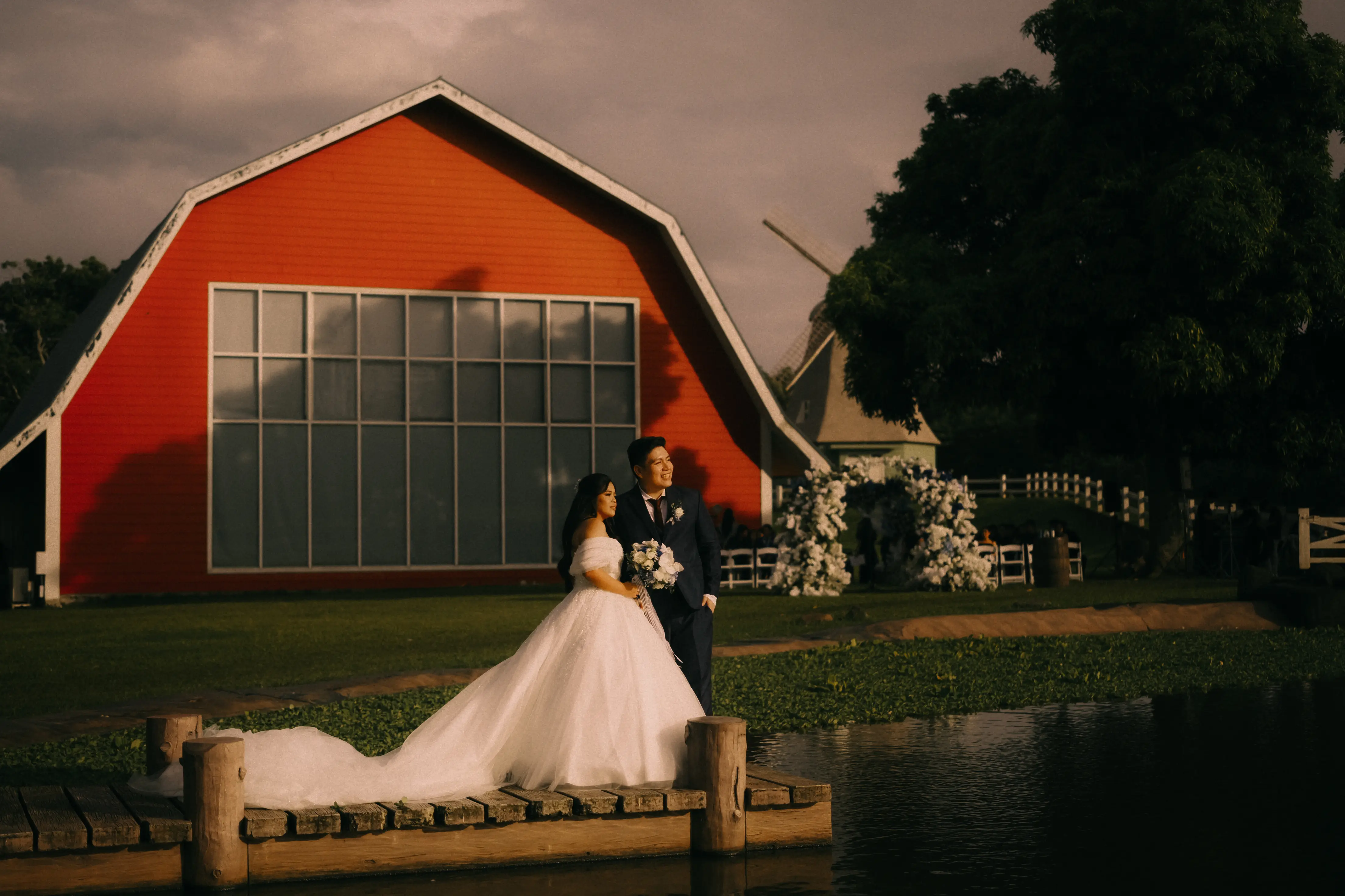 fran and luisa sunset photo on a wooden bridge with the oldgrove barn in the background