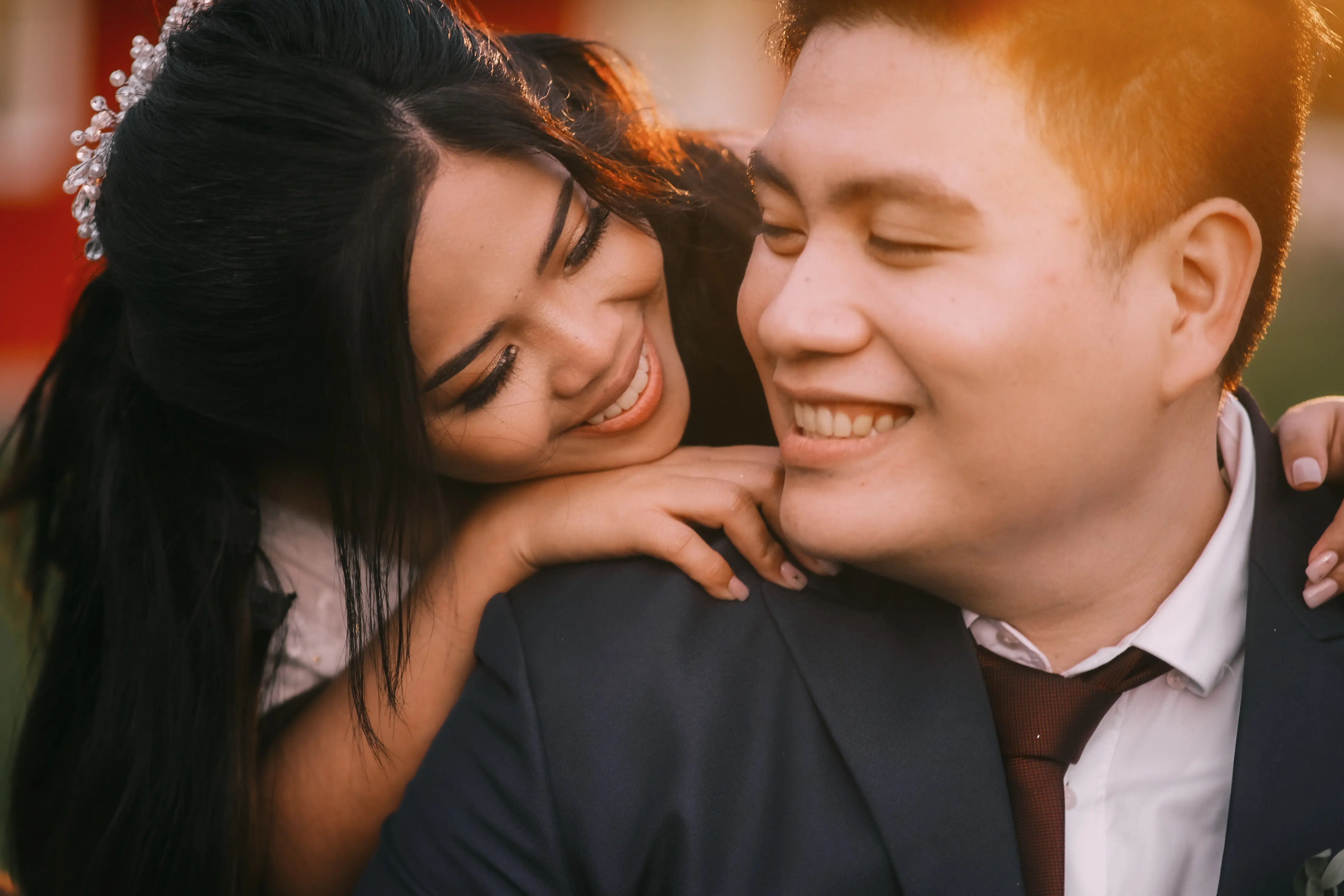 closeup photo of fran and luisa smiling side by side in their wedding attire