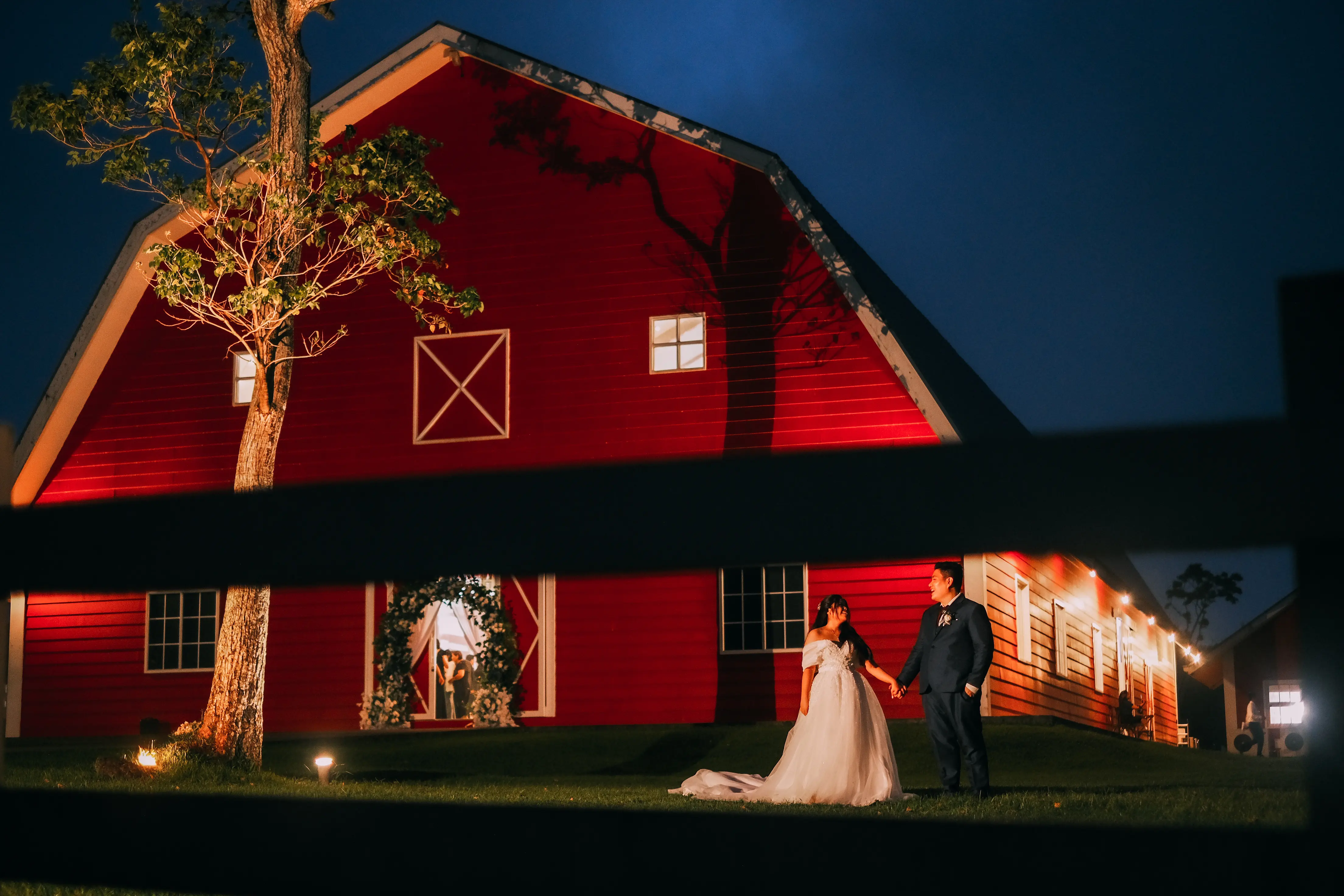 fran and luisa photo in front of the oldgrove barn entrance at night